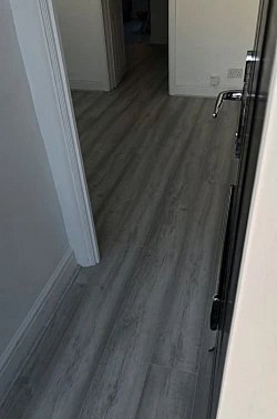 Wood Laminate Flooring. Supply and installed the finish has grey synchronised colour matching  Scotia beading, Halton, Merseyside, Runcorn, Cheshire areas are available