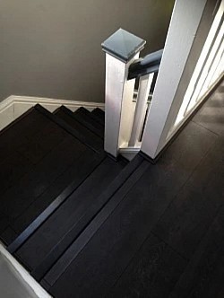 Laminate flooring Supply | flooring near me | laminate on  installation stairs finished in carbon black + synchronised black beading and colour matching flooring accessories